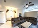 Inviting living room featuring a comfortable sectional sofa, ceiling fan, and unique deer head decor at 14399 Morristown Ave, Port Charlotte, FL 33981