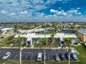 Beautiful waterfront community featuring lush landscaping, private parking, and stunning water views at 1461 Aqui Esta Dr # B3, Punta Gorda, FL 33950