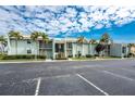 A full view of the exterior of a condominium building on a sunny day at 1461 Aqui Esta Dr # B3, Punta Gorda, FL 33950