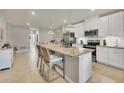 Island kitchen with granite countertops, white cabinetry, and stainless steel appliances at 16273 Coconut Palm Dr, Port Charlotte, FL 33953