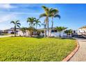 Inviting single-story home with mature palm trees and well-maintained lawn at 1960 Mississippi Ave, Englewood, FL 34224