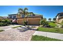 Charming two-story townhome with an attached garage, and lush landscaping at 20110 Ragazza Cir # 102, Venice, FL 34293