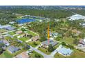 Aerial view showcasing the home's location near a lake, wooded area, and nearby recreation at 224 Pine Glen Ct, Englewood, FL 34223