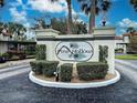 Beautiful community entrance sign surrounded by lush landscaping in Pine Hollow at 409 Pine Hollow Cir # 409, Englewood, FL 34223