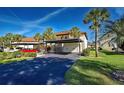 Property offers convenient covered parking, enhanced by mature palm trees at 409 Pine Hollow Cir # 409, Englewood, FL 34223
