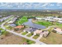 An aerial view displays multiple homes with golf course and water views in a desirable community at 7 Windward Rd, Placida, FL 33946