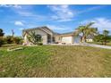Well-maintained single-story home featuring a two-car garage and landscaped front yard at 7151 Cork Ln, Englewood, FL 34224