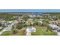 A bird's-eye view of a residential area featuring a home with a pool and peaceful surroundings at 8164 Archie St, Englewood, FL 34224