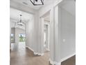 Bright hallway with tile floors, decorative light fixtures, and architectural details at 8375 E Windbound Ct Ct, Sarasota, FL 34240