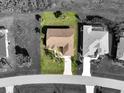 An aerial view of a well-maintained single-Gathering home featuring a lush green lawn at 127 White Marsh Ln, Rotonda West, FL 33947