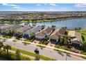 Beautiful aerial view of waterfront homes showcasing well-manicured lawns and tile roofs at 13137 Oriago St, Venice, FL 34293