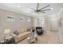 Comfortable living room with tile floors, modern ceiling fan, and neutral decor at 13137 Oriago St, Venice, FL 34293