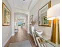 Welcoming foyer with wood-look tile flooring, elegant decor, and arched passageway at 1409 Remington Trace Dr, Port Charlotte, FL 33953
