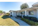 Charming single-story home with a well-manicured lawn and inviting front porch, plus established landscaping at 1456 Deer Creek Dr, Englewood, FL 34223