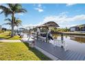 Scenic view of a private boat dock on the canal, perfect for boating enthusiasts and waterfront living at 15578 Seafoam Cir, Port Charlotte, FL 33981