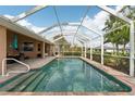 Relaxing screened-in pool with brick accents and a spacious deck with lounging and dining furniture at 16137 Alcira Cir, Punta Gorda, FL 33955