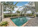 Inviting screened-in pool with brick-paver deck and clear blue water, perfect for relaxation and outdoor enjoyment at 16137 Alcira Cir, Punta Gorda, FL 33955