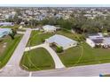 Lovely aerial view of a charming single-story home boasting a circular driveway and lush landscaping at 2545 Geneva Rd, Venice, FL 34293