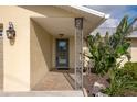 Welcoming front entrance with tiled porch, decorative columns, and a stylish glass-paneled front door for a grand entry at 2545 Geneva Rd, Venice, FL 34293