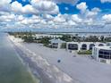 An aerial view capturing beachfront condos with scenic beach access and views of the surrounding coastal community at 2820 N Beach Rd # 101, Englewood, FL 34223