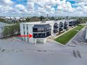 Condominium exterior featuring private balconies with relaxing seating and beach access, offering a coastal living experience at 2820 N Beach Rd # 101, Englewood, FL 34223