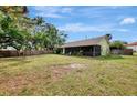 Large grassy backyard is fenced and features a screened porch, perfect for outdoor living at 35 Michigan Ave, Englewood, FL 34223