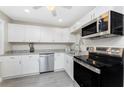 Well-lit kitchen featuring stainless steel appliances and sleek cabinets at 5041 N Beach Rd # 3A And 3B, Englewood, FL 34223