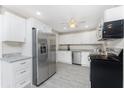 Open kitchen with stainless steel appliances and spacious refrigerator at 5041 N Beach Rd # 3A And 3B, Englewood, FL 34223