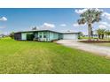 Inviting home with a lush green lawn and an attached two-car garage at 52 Golfview Ter, Rotonda West, FL 33947