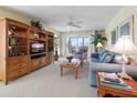 Cozy living room with built-in shelving, comfortable seating, and access to outdoor balcony at 7237 Rum Bay Dr # 5022, Placida, FL 33946
