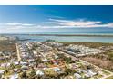 Captivating aerial view of a coastal community with waterfront homes and a house encircled in red for focus at 8159 Archie St, Englewood, FL 34224