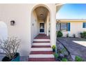 Charming front porch with brick steps and decorative plants leading to the front door at 8159 Archie St, Englewood, FL 34224