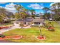 Charming home with solar panels and a well-manicured lawn, complemented by tasteful landscaping at 840 E 7Th St, Englewood, FL 34223