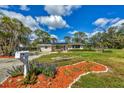 Beautiful single-story home featuring vibrant landscaping, solar panels, and a convenient mailbox at 840 E 7Th St, Englewood, FL 34223