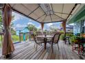 Back patio with seating and a sunshade creating the perfect spot for outdoor dining and relaxation at 849 Palmetto St, Englewood, FL 34223
