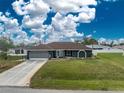 Charming home featuring a well-manicured lawn and inviting architecture at 10075 Bay Ave, Englewood, FL 34224