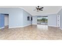 Bright living room with tile floors and access to the pool area at 10075 Bay Ave, Englewood, FL 34224