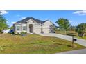 Charming home featuring a well-manicured lawn, a two car garage and neutral toned exterior paint at 10498 Bay State Dr, Port Charlotte, FL 33981