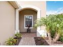 Charming entryway featuring an arched entryway, brick floor, and decorative accents at 11417 Okaloosa Dr, Venice, FL 34293