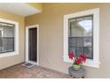 Welcoming front porch with brick flooring, ample natural light and neutral paint at 11417 Okaloosa Dr, Venice, FL 34293