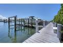 Modern boat dock featuring a boat lift, providing easy and secure access to the water at 13313 Gasparilla Rd # C501 & Slip 11, Placida, FL 33946