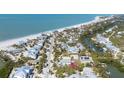 An aerial view of a charming coastal community with beach access and serene waterways at 14 Palm Dr, Placida, FL 33946