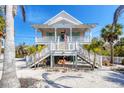 Lovely elevated beach house with double staircases, perfect for beachside living at 14 Palm Dr, Placida, FL 33946