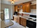Functional kitchen with wooden cabinets, neutral countertops, and modern appliances at 1417 Terry Ave, Punta Gorda, FL 33980