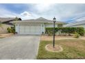 Charming single-story home with a well-maintained front yard and a two-car garage in a quiet neighborhood at 14281 Palm Ter, Port Charlotte, FL 33953