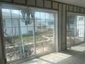 Bright sunroom featuring a tiled floor, large windows, and sliding glass doors at 1977 Beach Rd # 87, Englewood, FL 34223