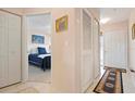 Inviting hallway with tile flooring, closet space, and artwork at 202 Silver Lake Dr # 203, Venice, FL 34292