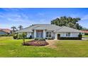 Charming one-story home with a well-maintained lawn and beautiful landscaping at 217 Rockwood Way, Englewood, FL 34223