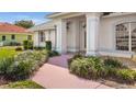 Inviting front entrance showcasing well-manicured landscaping and a charming walkway at 217 Rockwood Way, Englewood, FL 34223