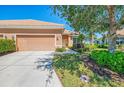 Inviting front exterior with manicured lawn, mature trees, and attached two-car garage in a residential neighborhood at 2625 Wax Myrtle, Port Charlotte, FL 33953